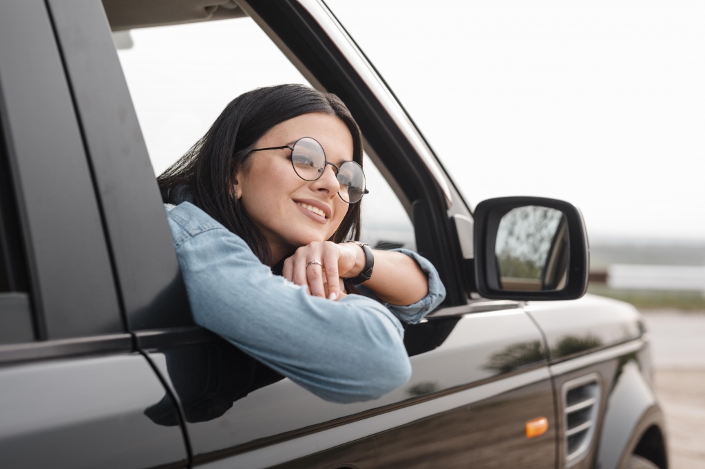 smiley-woman-traveling-alone-by-car.jpg