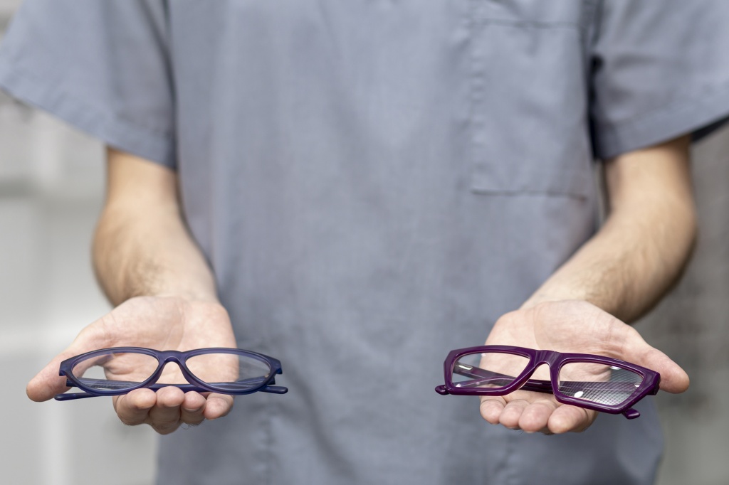 front-view-of-man-holding-a-pair-of-glasses-in-each-hand.jpg